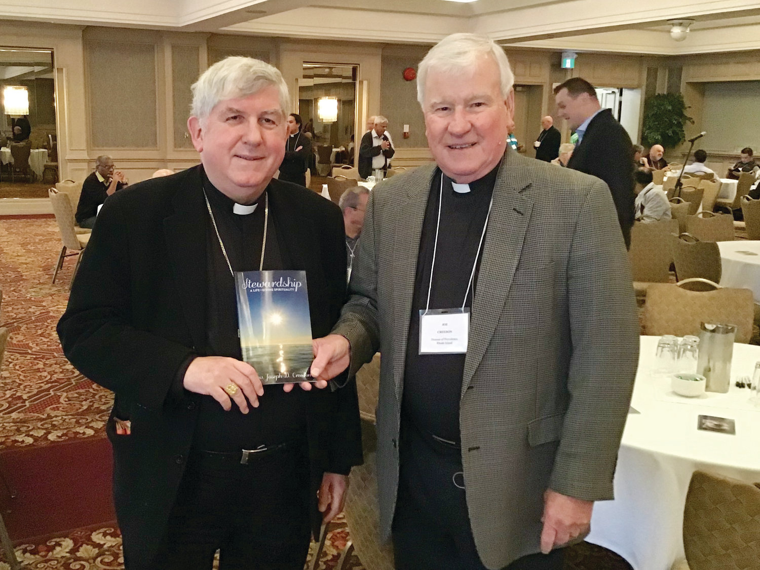 Father Joseph Creedon, right, presents a copy of his book, “Stewardship: A Life-Giving Spirituality” to Cardinal Thomas Collins, the archbishop of Toronto. Father Creedon was in Toronto last fall to speak to the priests of the archdiocese about the spirituality of Stewardship.